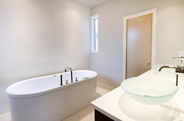 Oval tub and glass sinks add interest