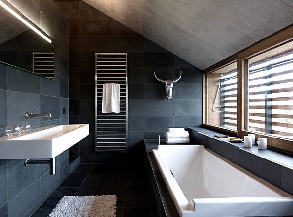 White and metallic details in a dark gray bathroom