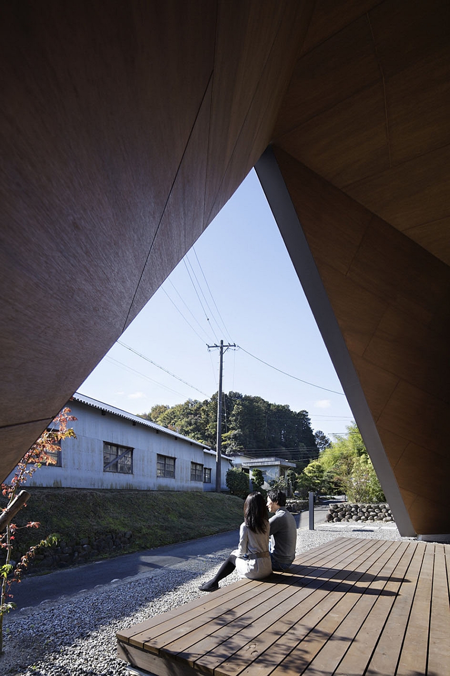 Origami styled, tent-shaped roof offers ample shade to the house