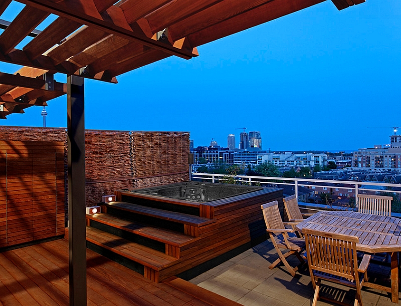 Rooftop patio with a hot tub and a wooden deck offers stunning views of Toronto skyline