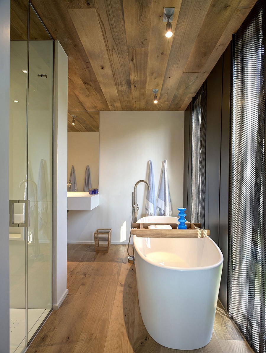 Beautiful bath with a stylish standalone tub and blue accents