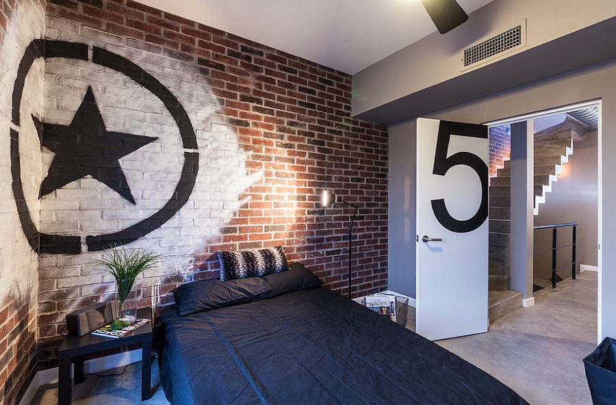 Industrial style bedroom with brick wall and trendy graffiti art