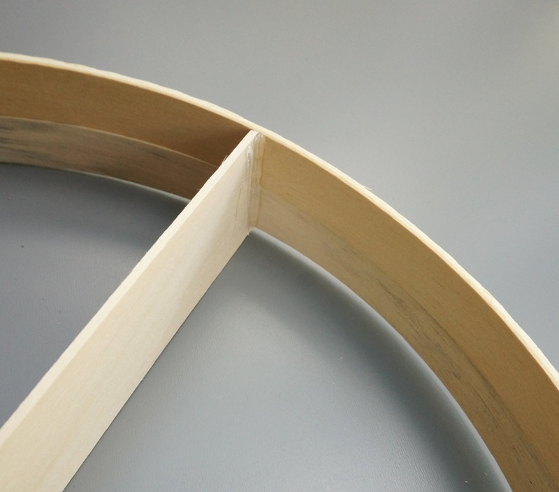 Hot glue on the underside of the round shelf
