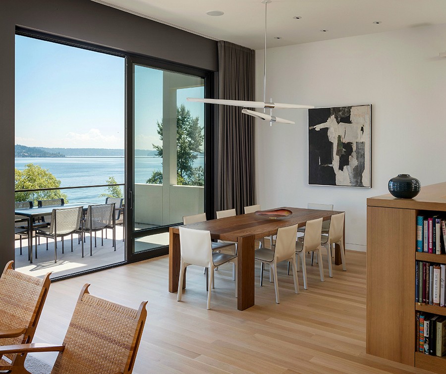 Indoor and outdoor dining space with a lake view