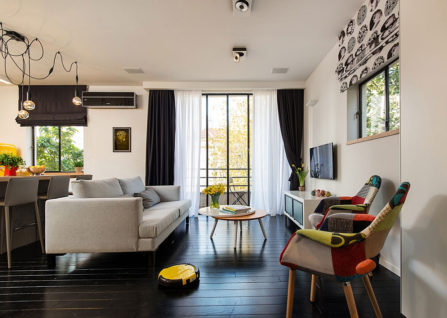 Painted black floor gives the small living room a sophisticated appeal