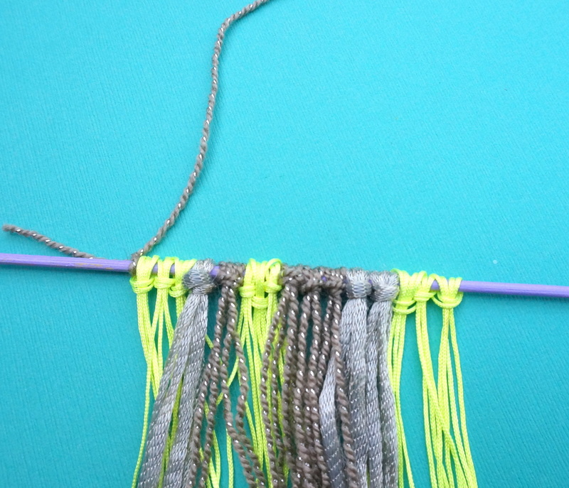 Form a wall hanging handle with yarn