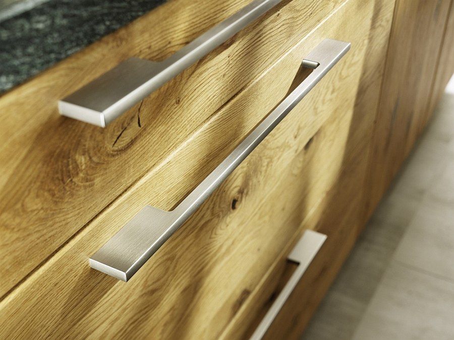 Metal handles complement the hand-sorted wooden surfaces of the Loft kitchen