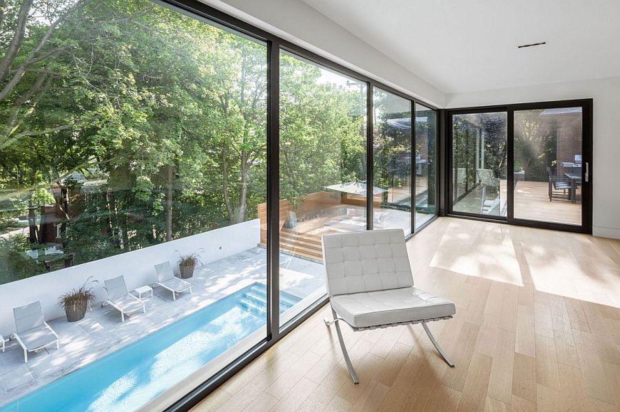 Elegant view of the landscaped terrace and pool from the extension