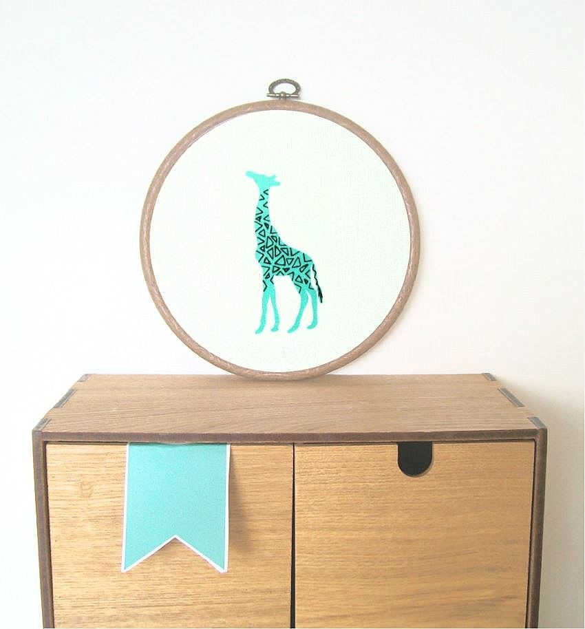 Aqua giraffe with black geomteric designs