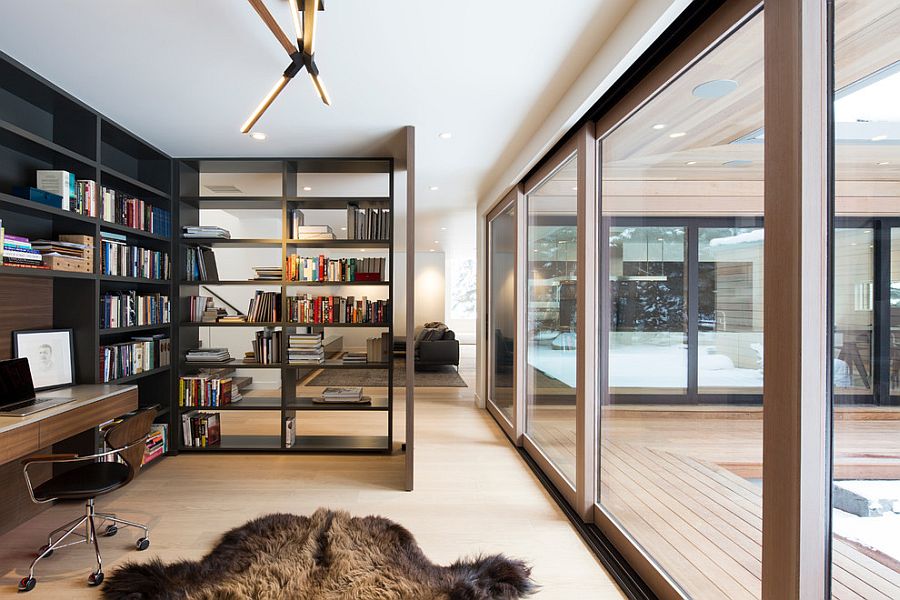 Open bookshelf adds as a divider between the home office and living room