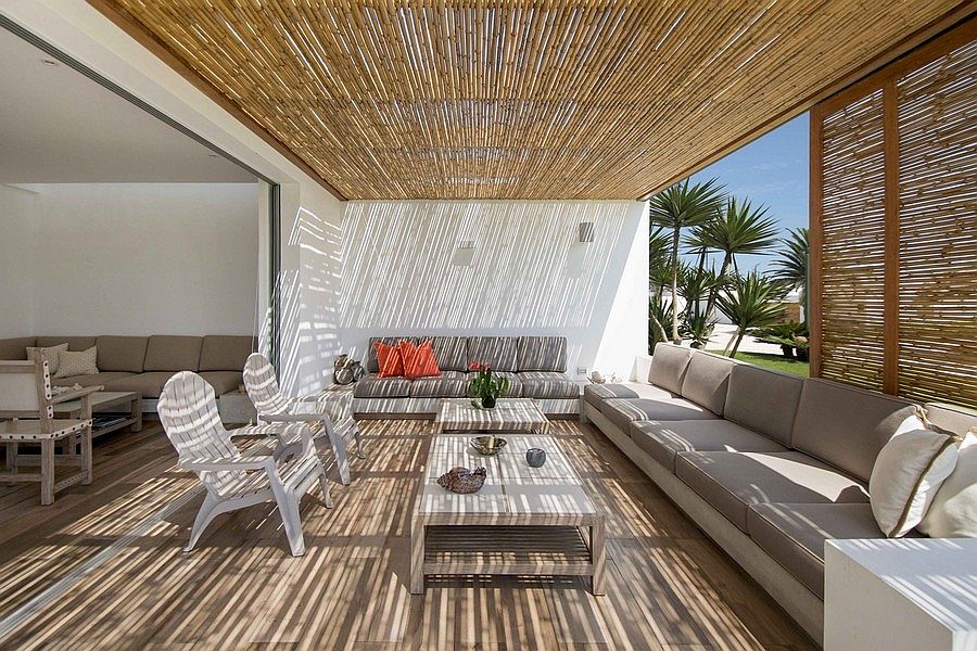 Comfy outdoor lounge area with bamboo blinds and plush seating