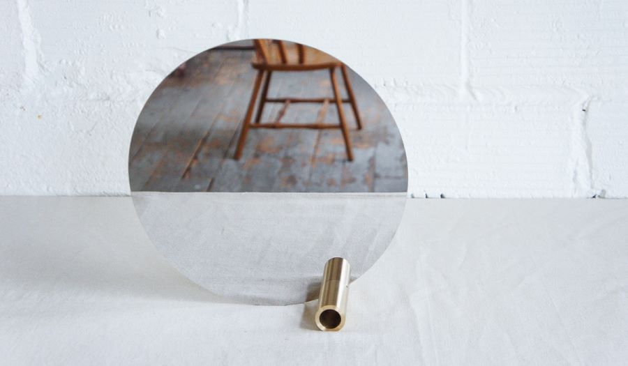 Round mirror with a brass tube