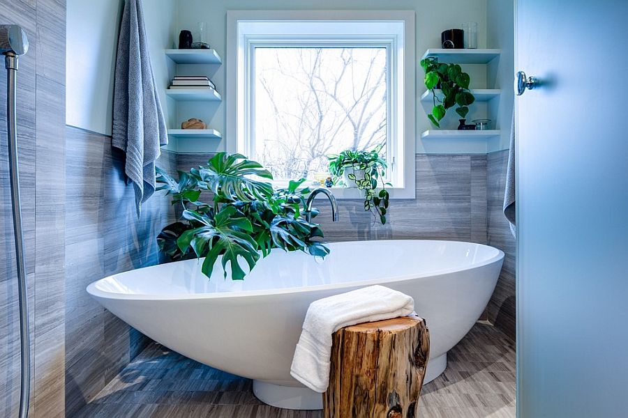 There is no shortage of greenery in this contemporary bathroom with a tropical edge