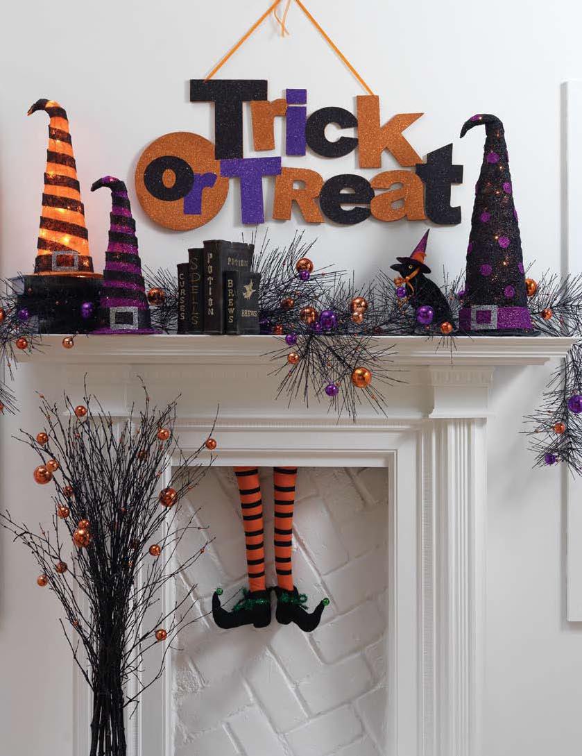 Glitterly orange and purple Halloween mantel decor with witch legs