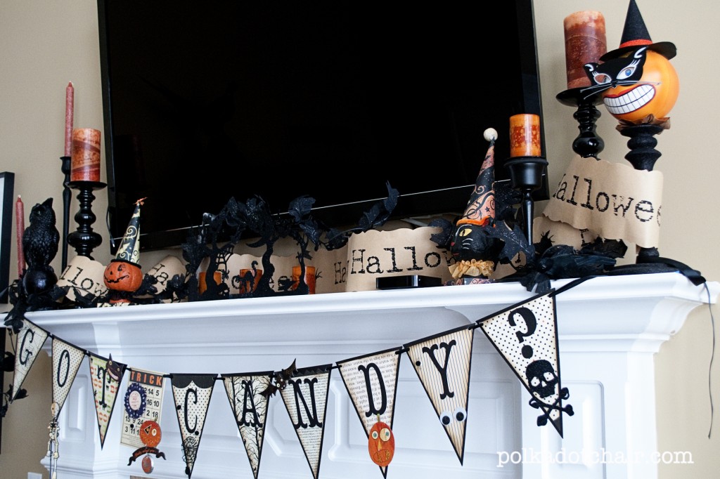 Small Halloween decorations on a mantel with a TV