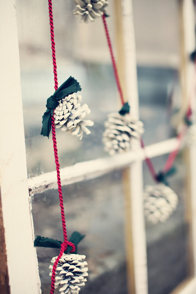 Frosted pinecone garland with green ribbon and red rope