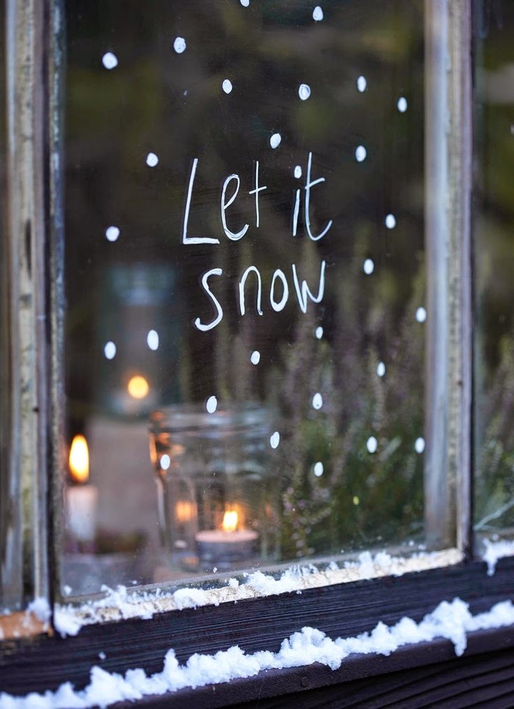 'Let It Snow' written on window in temporary white window marker