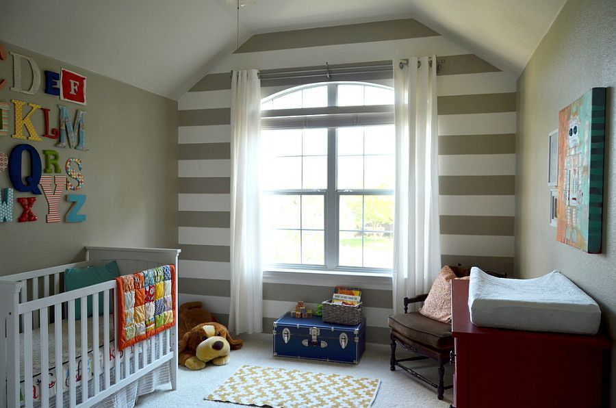 Elegant nursery for a baby boy with striped feature wall