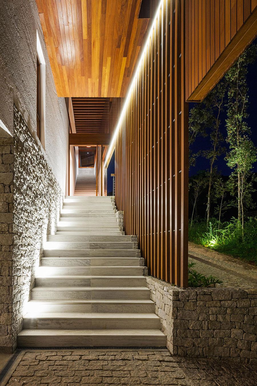 Beautiful lighting illuminates the stairway leading to the Brazilian home