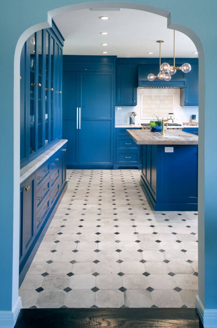 Blue walls introduce a kitchen with blue cabinets