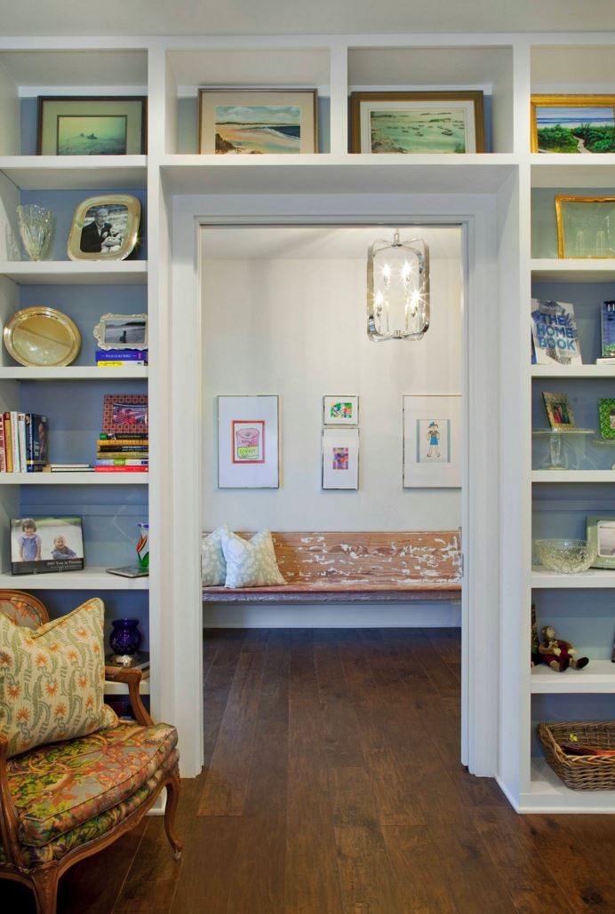 Bookshelf-lined room with a gallery wall view