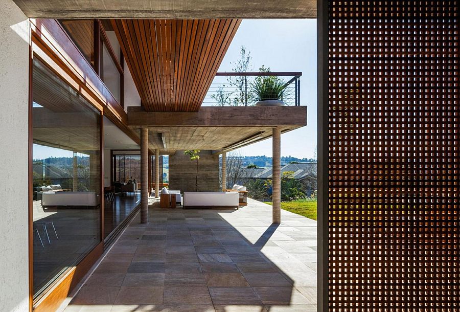 Concrete balcony acts a pergola for the loower level deck