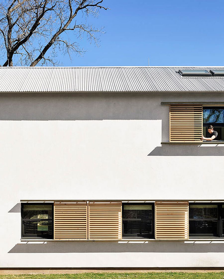 Series of windows covered with wooden slats give the exterior a unique look