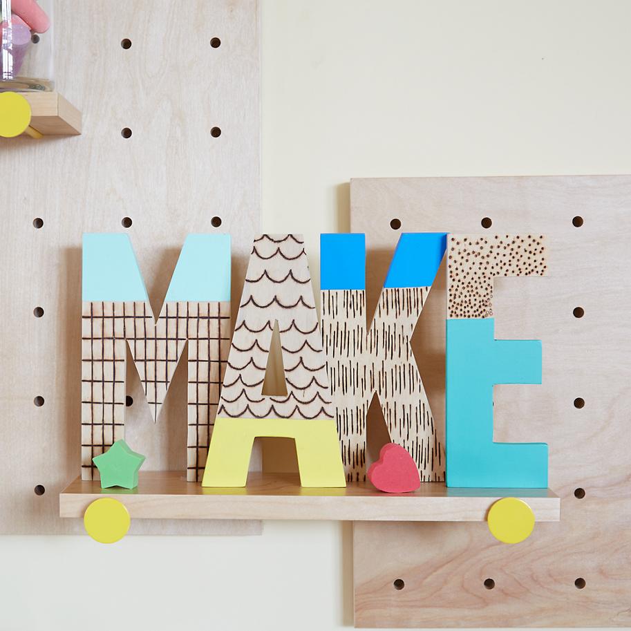Wood-burned letters from The Land of Nod