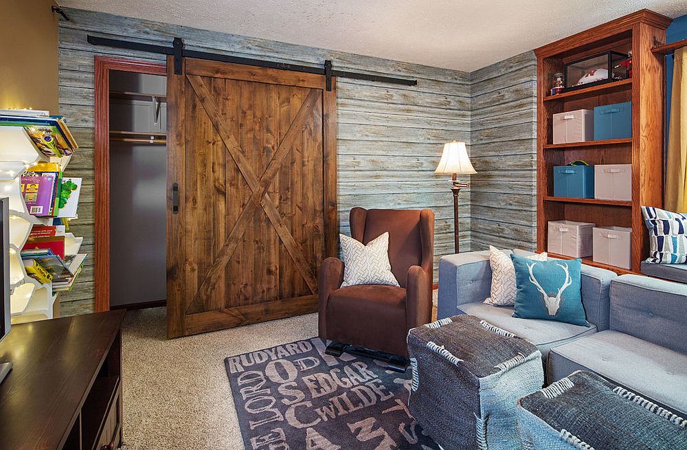 Kids’ media room and play area with a striking, sliding barn door