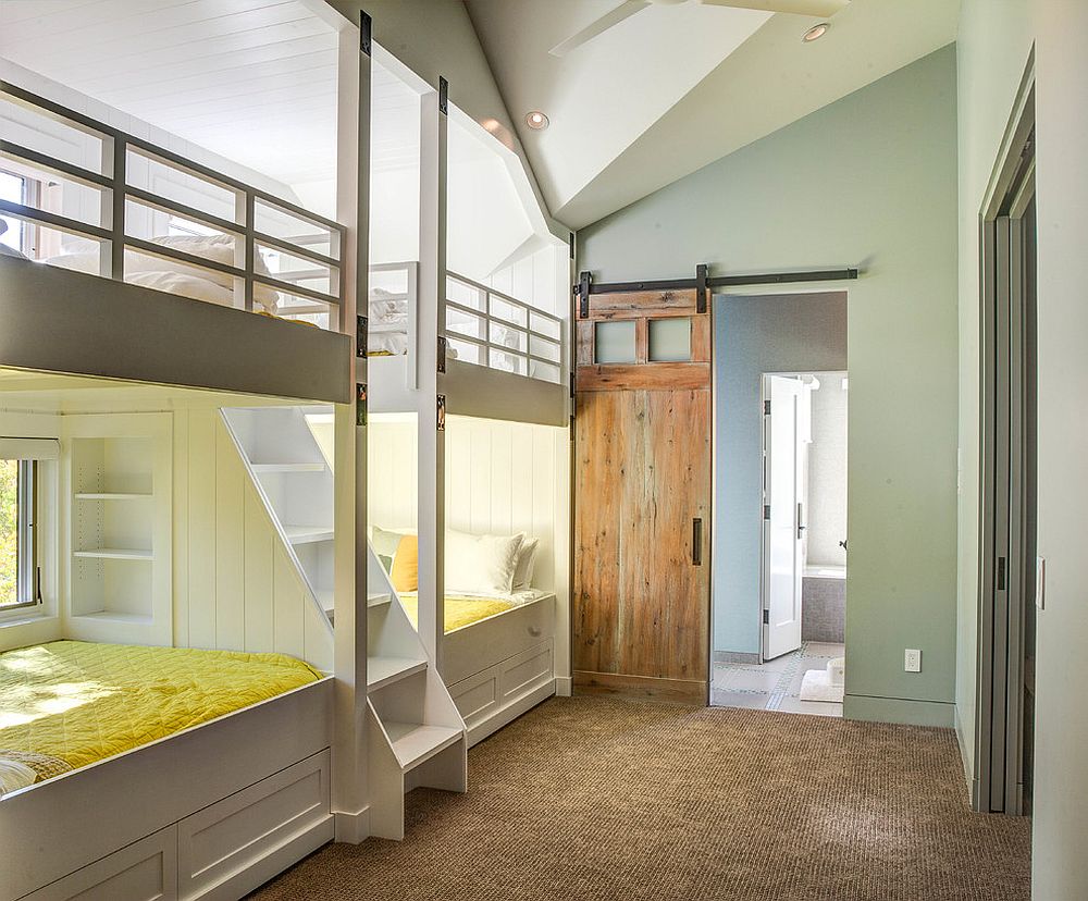 Sliding barn door in the kids’ room with wall of bunk beds is a space-saver