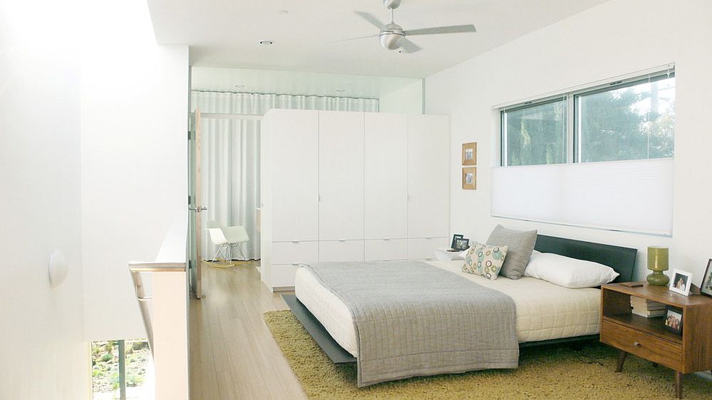 Custom built room divider also offers ample wardrobe space