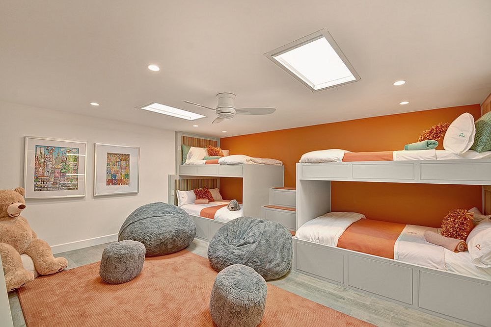 Wall of bunk beds in orange for the kids’ room