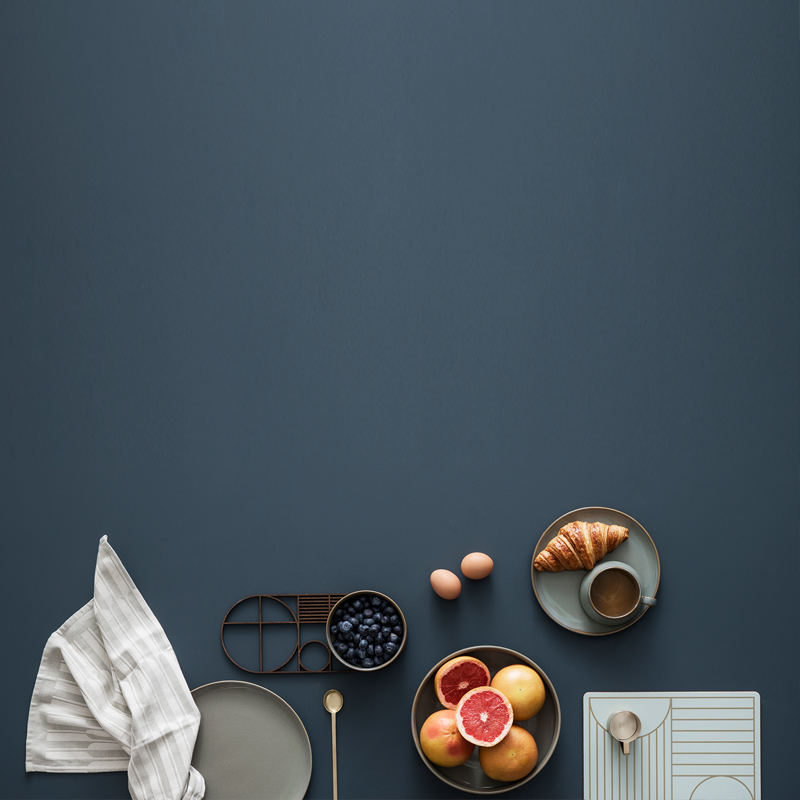 A rich grey backdrop highlights modern products by ferm LIVING