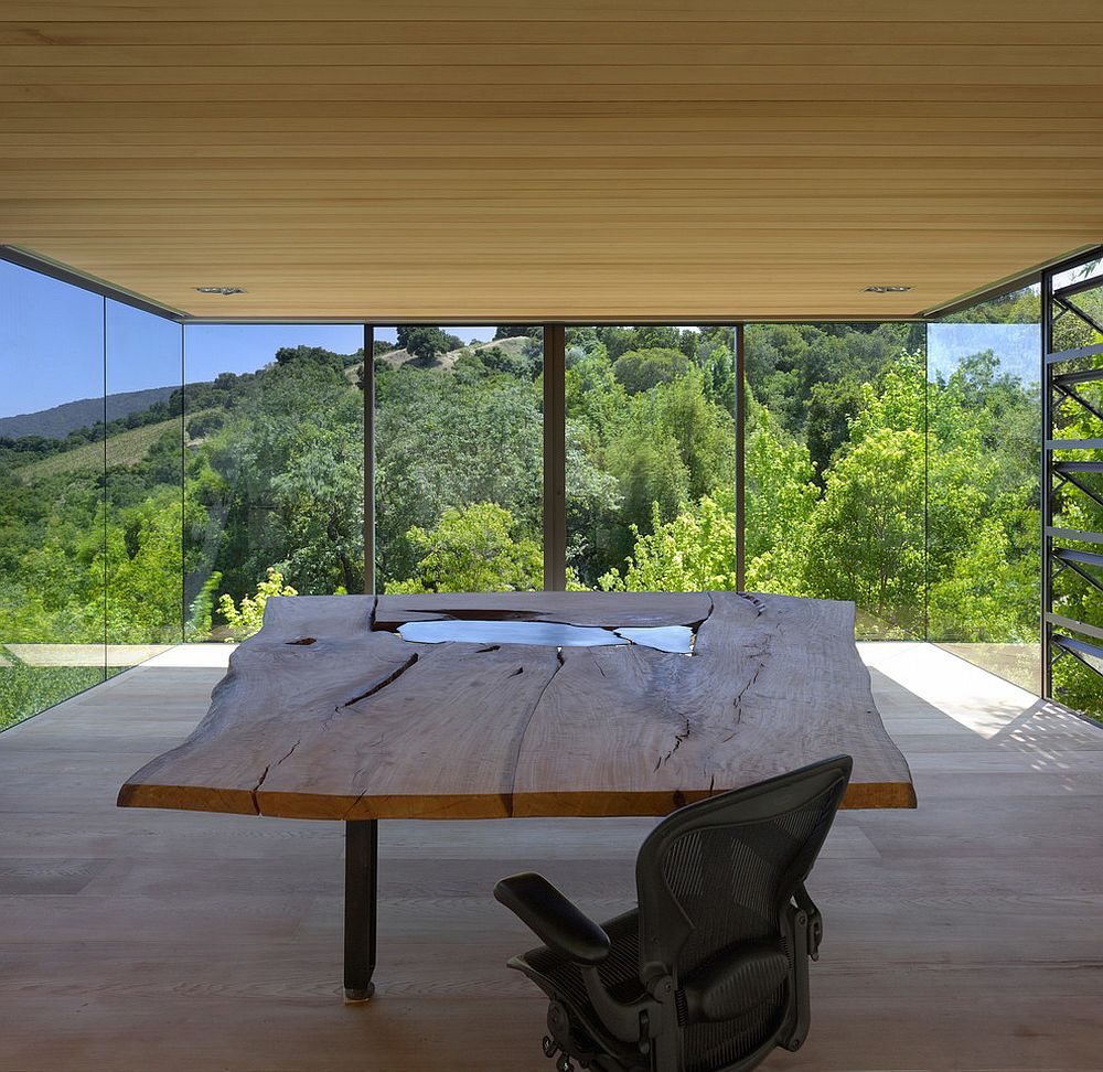 Glass walls of the home office bring natural greenery indoors