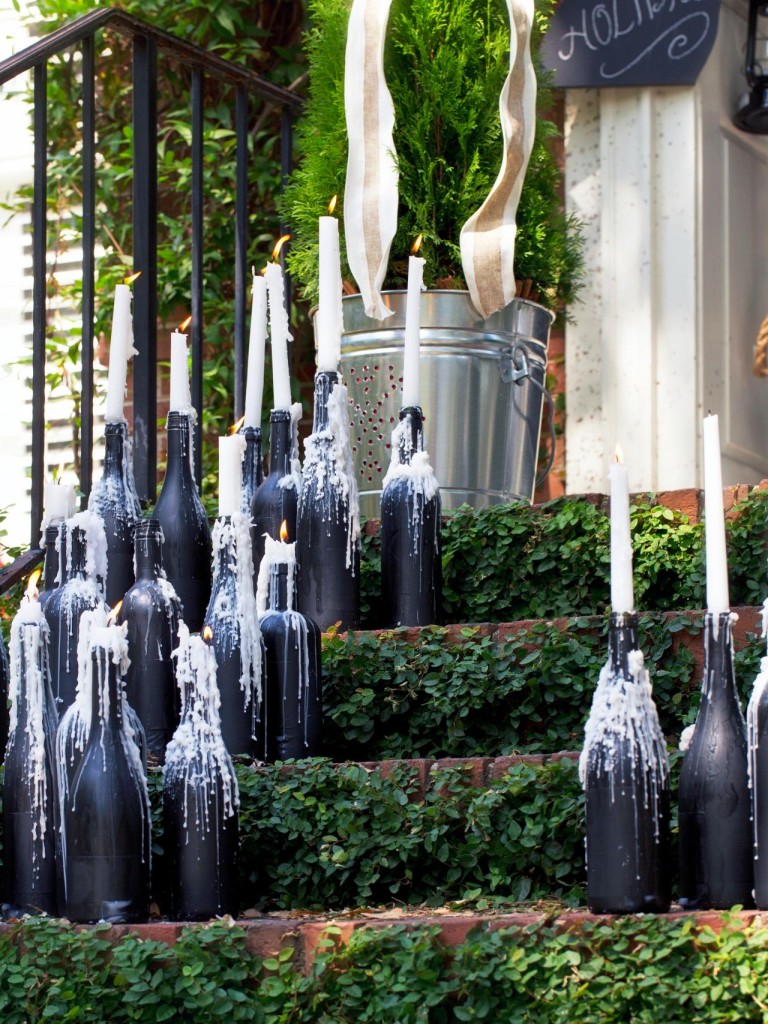 Wine bottles with dripping taper candles