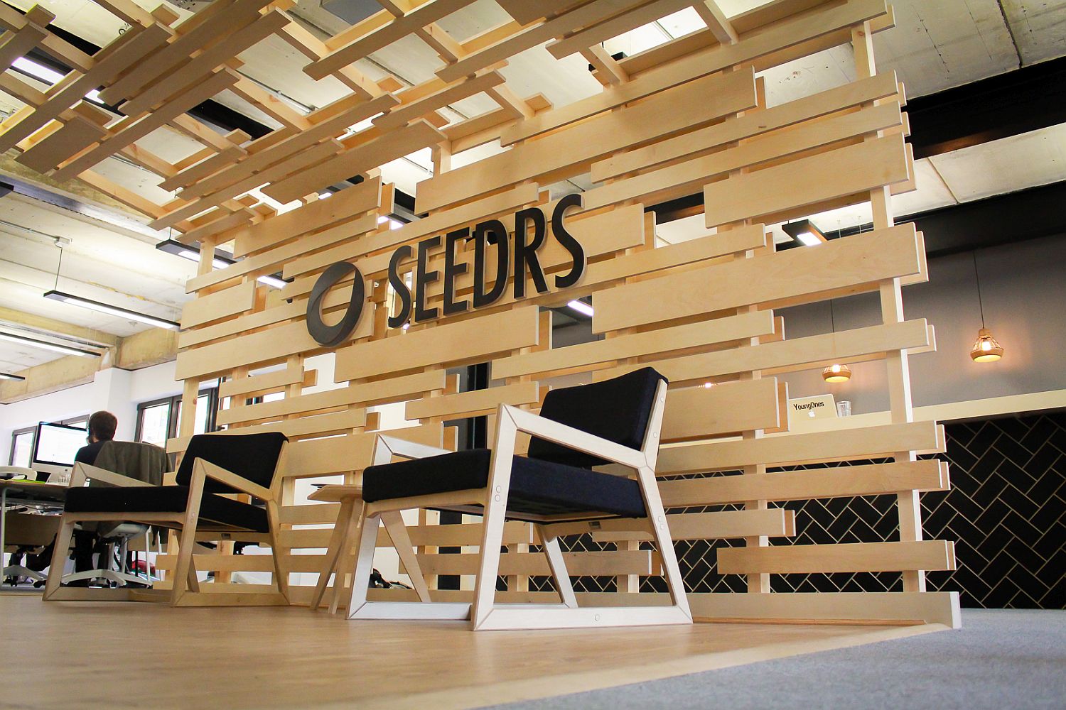 Birch ply backdrop and canopy gives the reception space a smart and cozy look