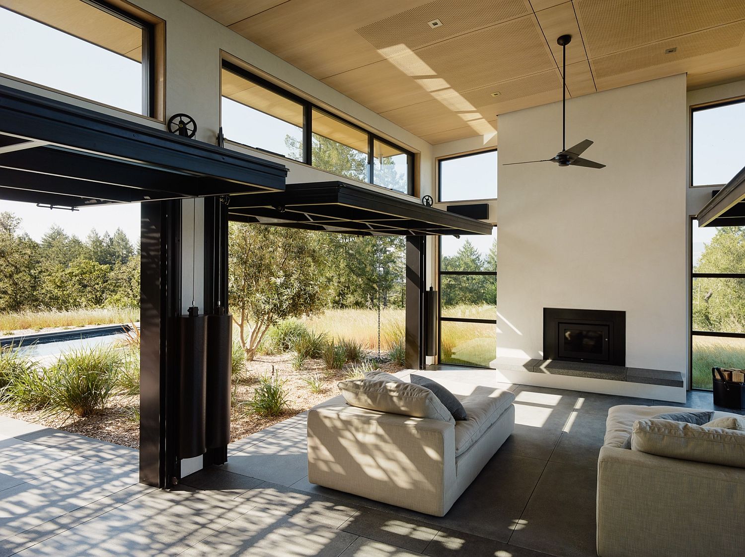 Operable doors and large glass windows connect the interior with the patio outdoor
