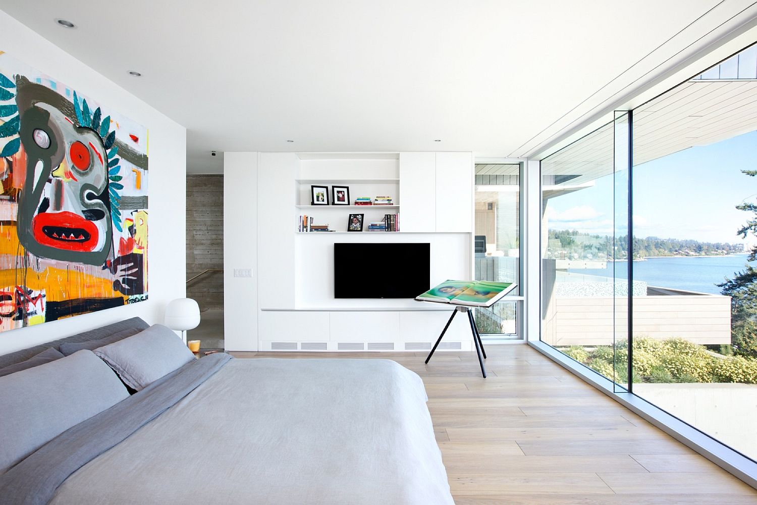 Contemporary bedroom with modern art above the bed and fabulous ocean view
