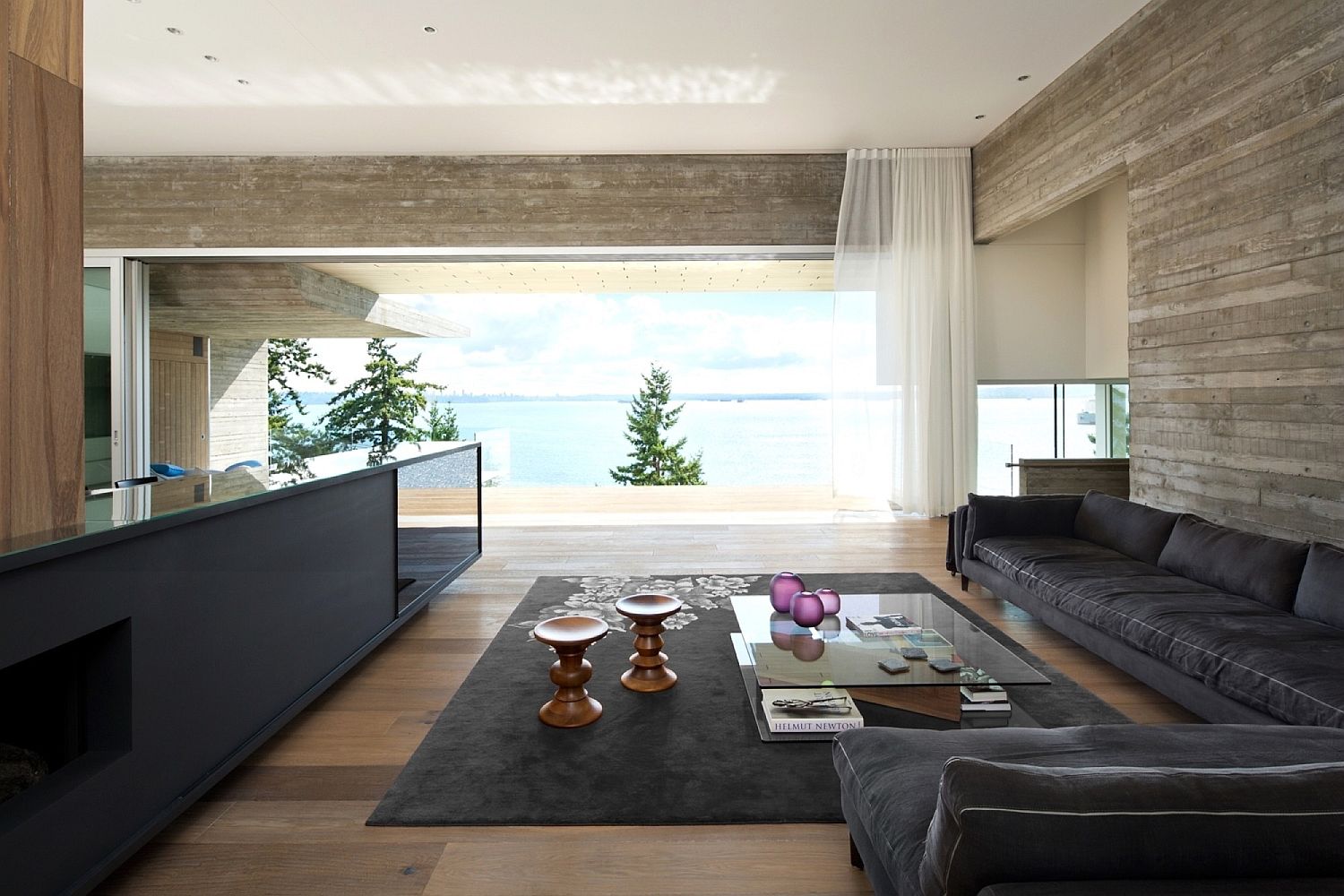 Living area clad in concrete, wood and leather with modern minimalism