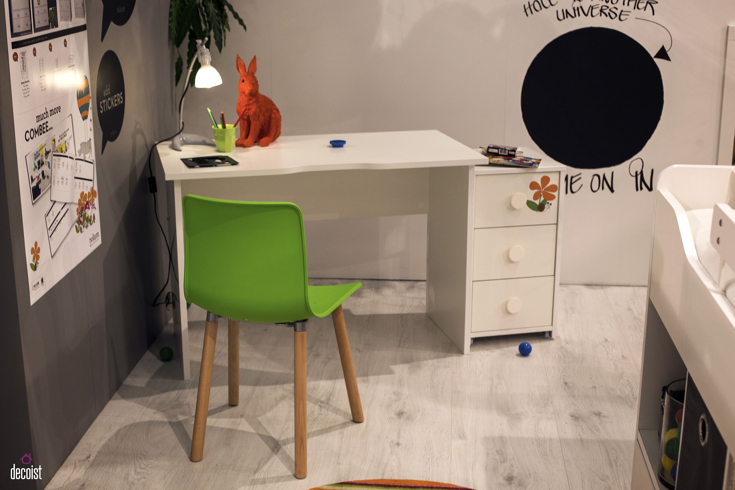 Minimal homeowrk station for the kids’ room in the corner with a colorful chair in green and a small cabinet