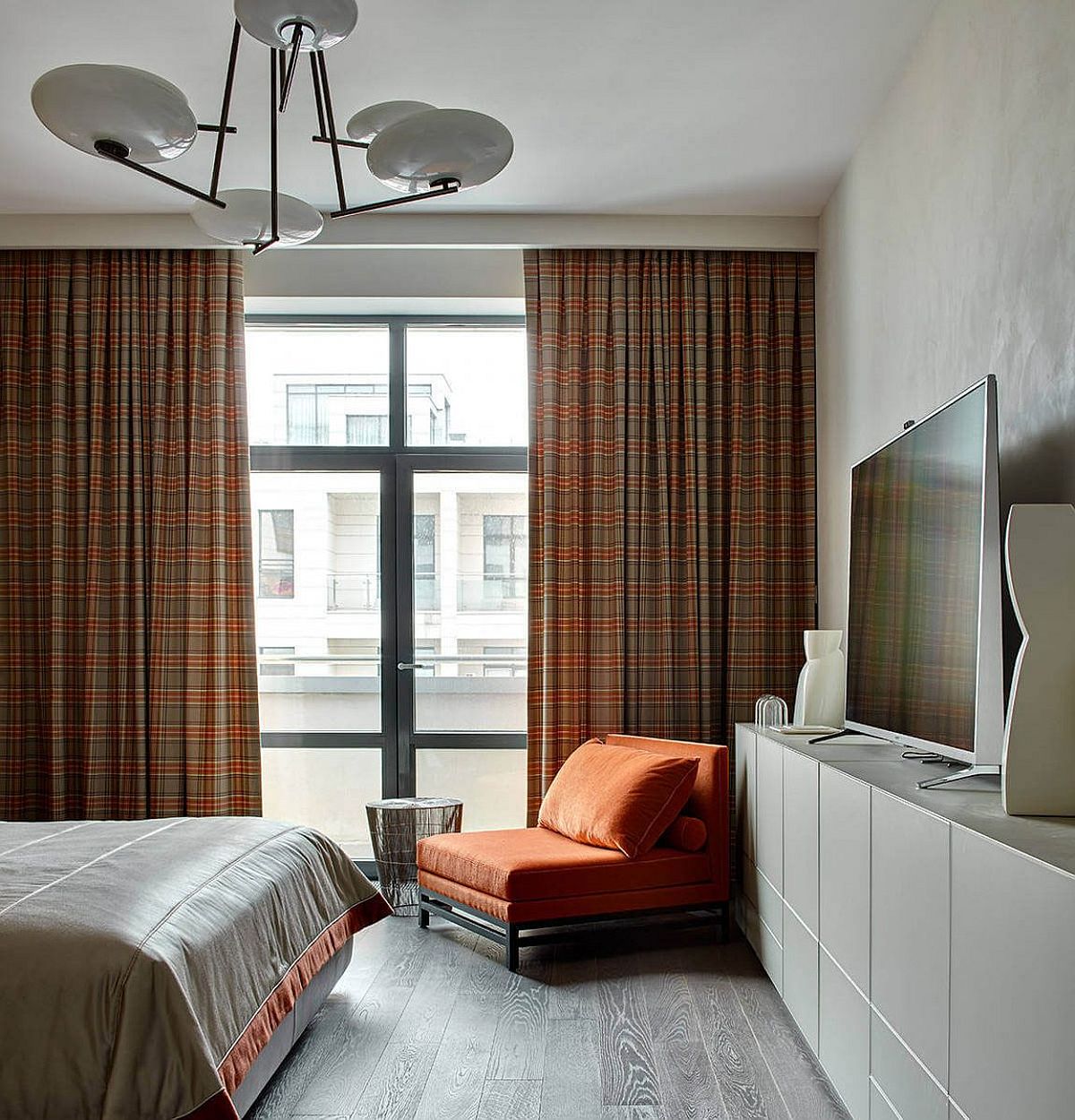 Plaid drapes add color and pattern to the neutral bedroom
