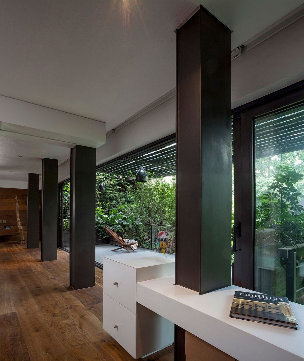 Small deck connected with the living area clad in wood