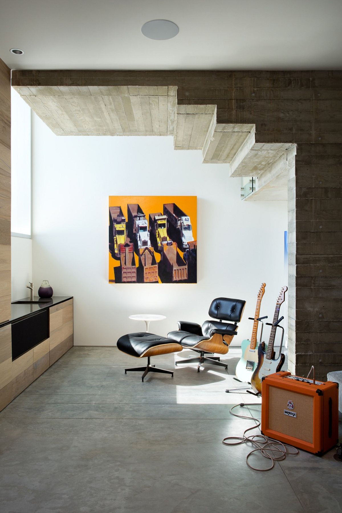 Small recreational and relaxation space under the stairway with the Eames Lounger