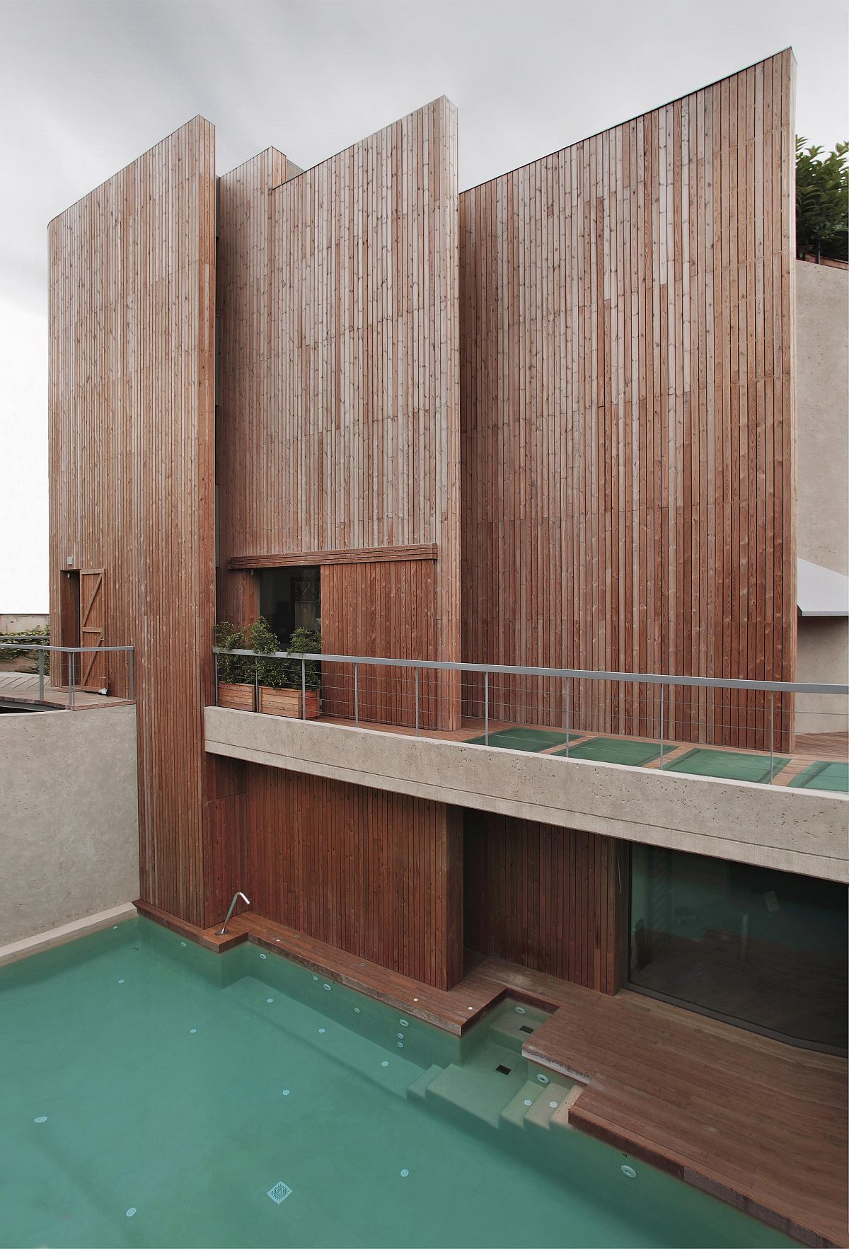 Wooden slats create a smart and bespoke facade that gives the Barcelona home a distinct look