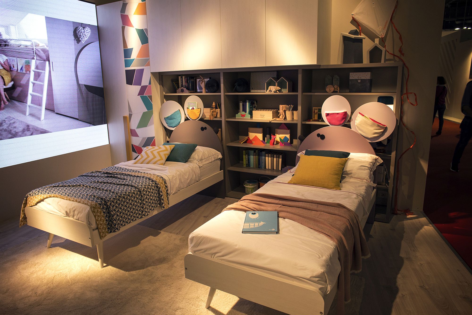 Modest kids’ bedroom with twin beds and ample shelf space