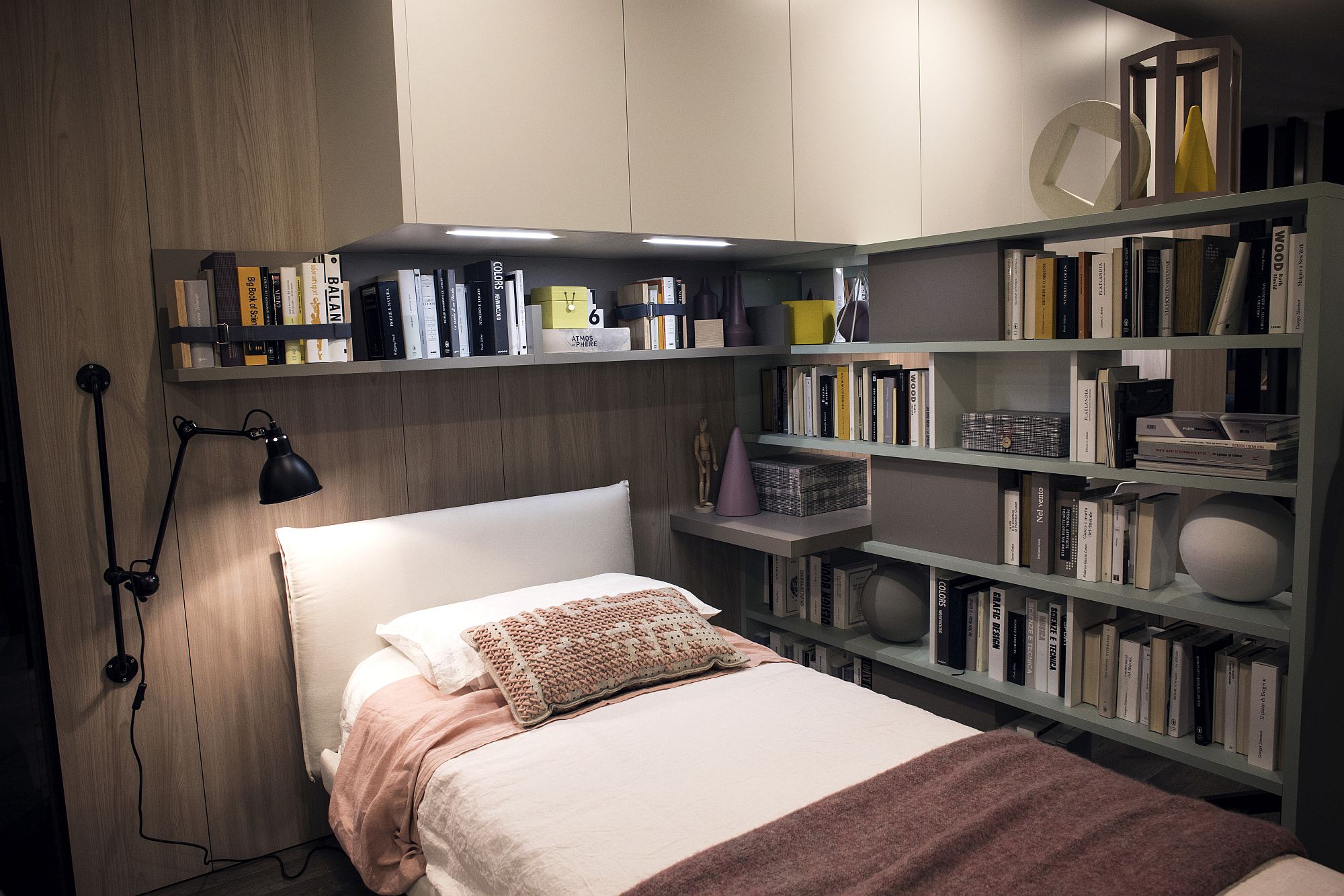 Series of open shelves around the bed helps stack all those books and toys