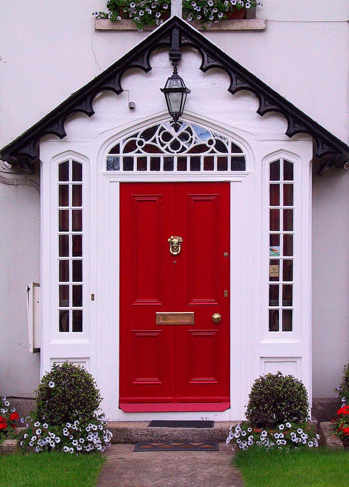 A charming house in light shade of pink with a red door