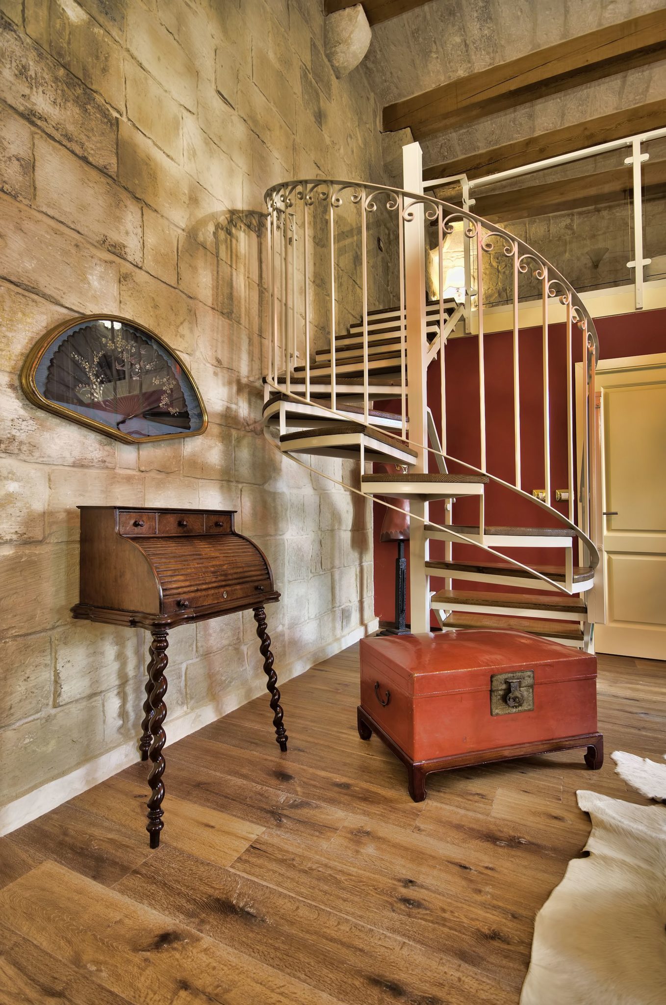 Spiral staircase leading to the aclove bedroom inside the first suite at Locanda La Gelsomina