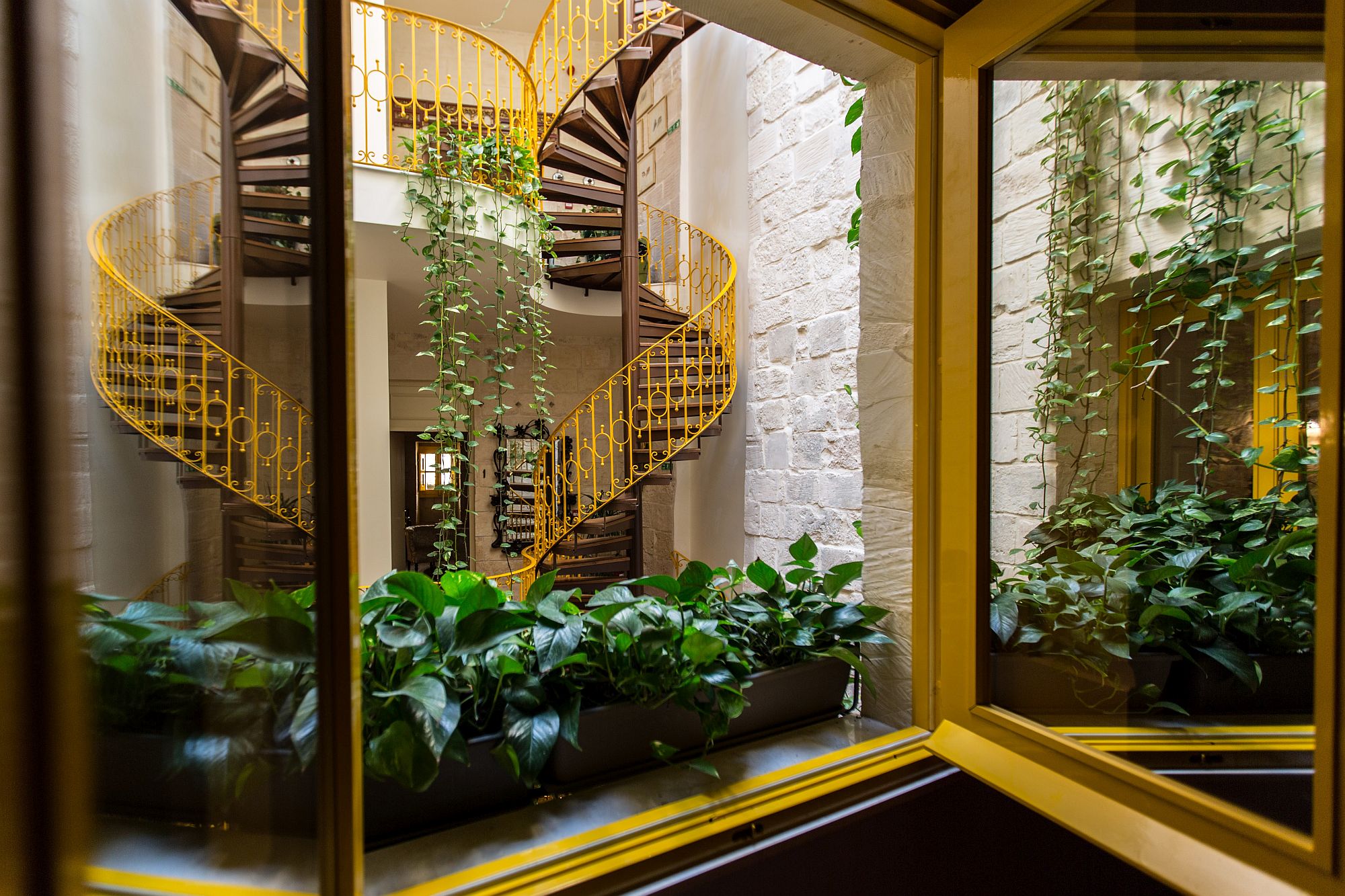 Stunning view of the spiral staircase and indoor greenery from the second suite