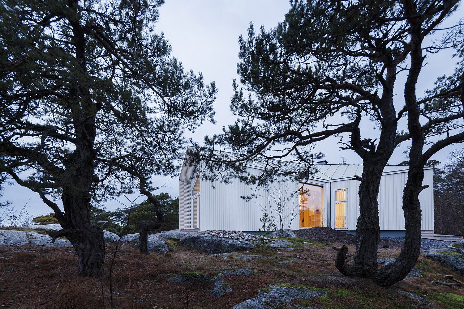 Villa walls cut into the bedrock of the landscape